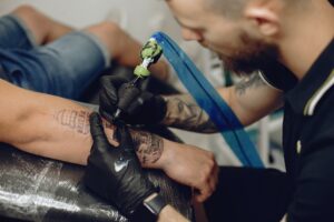 Man doing a tattoo in a tattoo salon